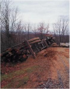 LOG TRUCK OVERTURNS ON SOFT WOODS ROAD